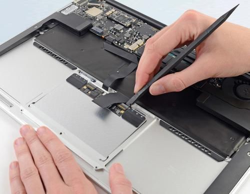 CoreParts MSPP74075 laptop display spare part, featuring a silver metal casing, with a hand using tweezers to connect components inside a laptop.