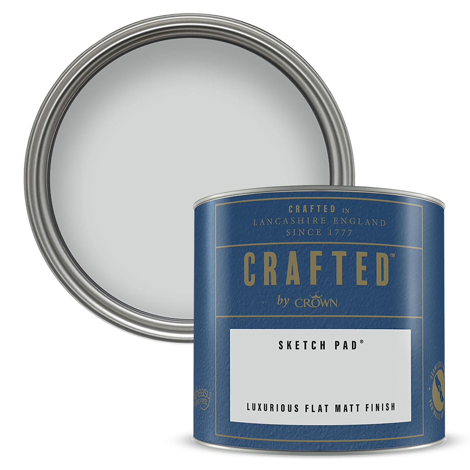 Round tin can of "Crafted by Crown" luxurious flat matt emulsion paint in "Sketch Pad" color, featuring a blue label with white text and a silver lid.