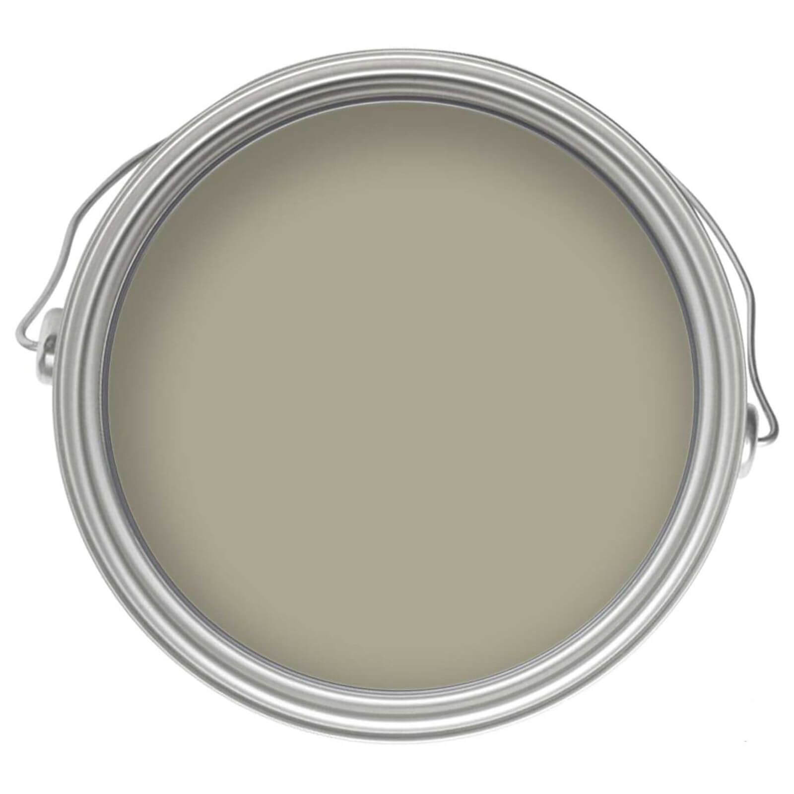 Round metal paint can with a silver lid, showcasing a smooth, olive green eggshell paint finish, labeled for interior use on wood and metal surfaces.