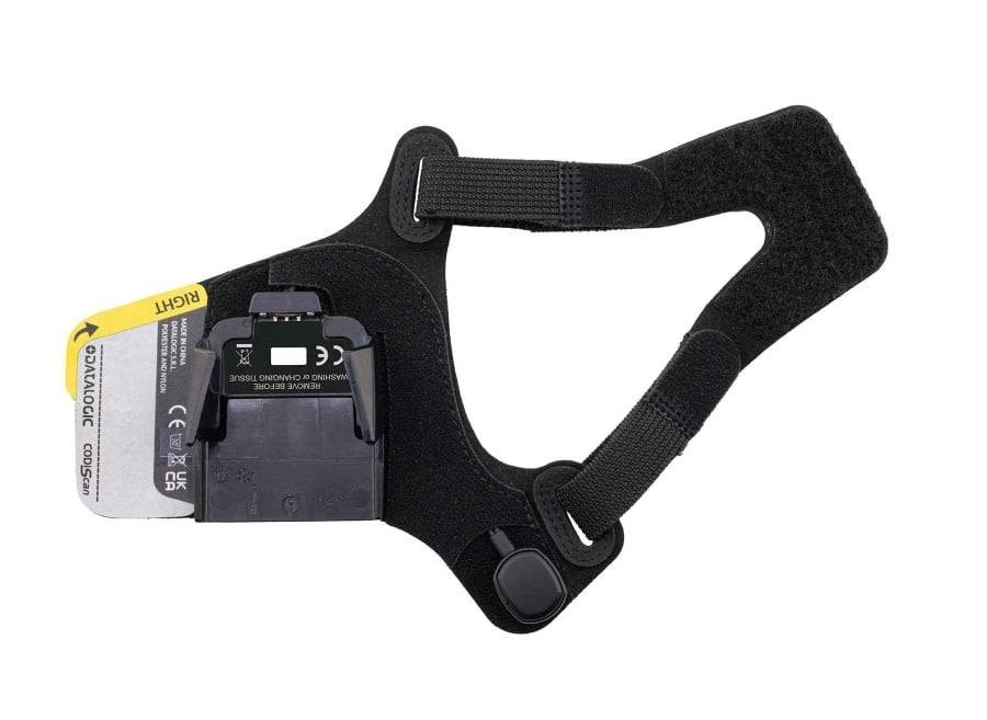 Black and gray hand mount with adjustable straps, featuring a yellow and black label, designed for secure attachment of Datalogic scanning devices.