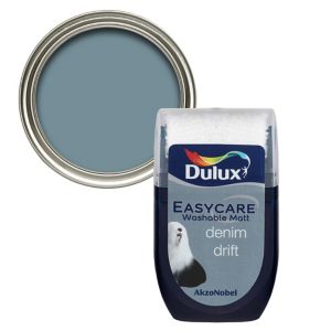 Dulux Easycare Denim Drift flat matt emulsion paint tester pot, featuring a soft blue-grey color, in a clear plastic container with a silver lid and a label displaying the product name.