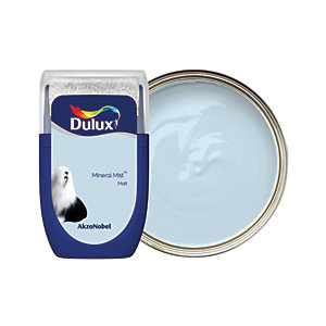 Dulux Colour Tester in Mineral Mist, 30ML, features a light blue paint in a round tin with a clear lid, showcasing a smooth texture and the Dulux logo prominently displayed.