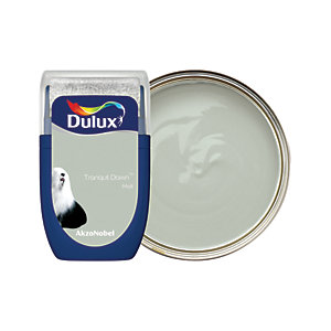 Dulux Matt Emulsion Paint in Tranquil Dawn, 30ml tester, featuring a soft green color in a round tin with a clear lid and a blue label showcasing the brand logo.