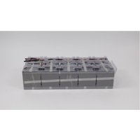 Rectangular Eaton UPS battery, gray with black top, featuring multiple cells and red-black wires on one end.