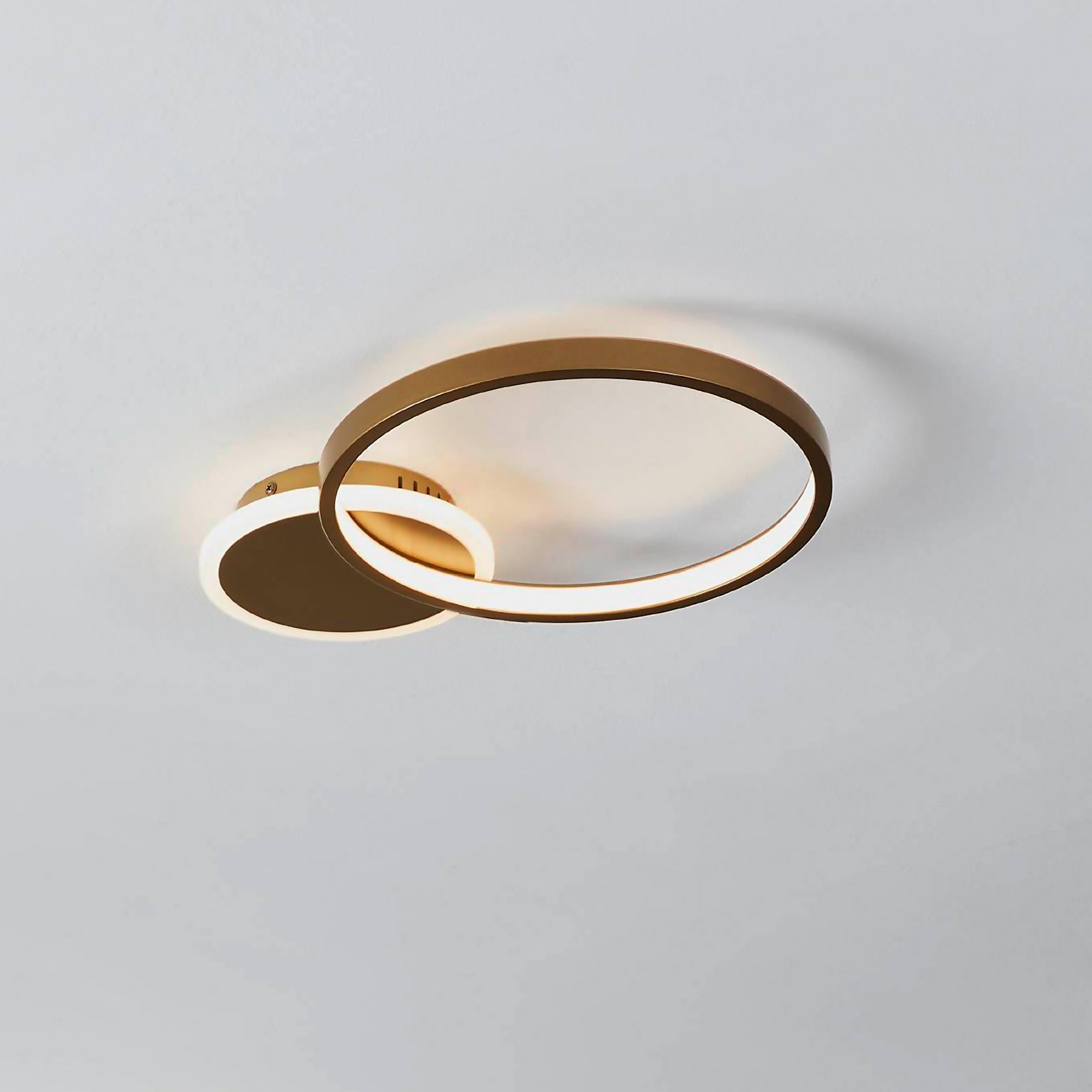 Gold and white circular flush ceiling light featuring a sleek design with a smooth finish and integrated LED lighting for modern illumination.