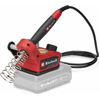 Red and black Einhell cordless soldering iron with coiled metal stand and black power cord on a gray base.