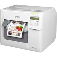 White Epson TM-C3500 label printer with LCD screen, control buttons, and labels emerging from the front slot.