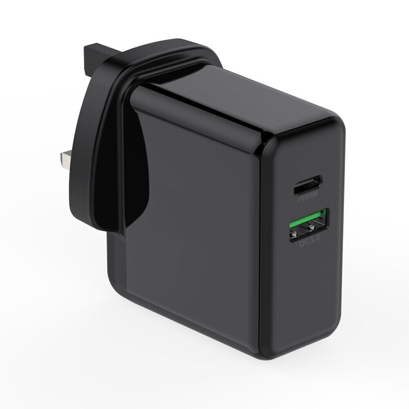 Black FDL charger with two ports: one USB-C PD and one USB-A QC3, featuring a sleek, glossy finish and compact design for efficient charging at 65W.