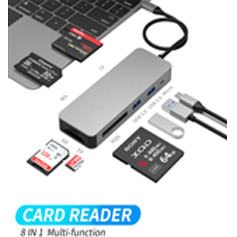 Silver 8-in-1 USB-C hub with two USB-A ports, a USB-C port, and multiple card slots for SD, TF, CF, MS, and XQD, connected to a laptop with memory cards displayed.
