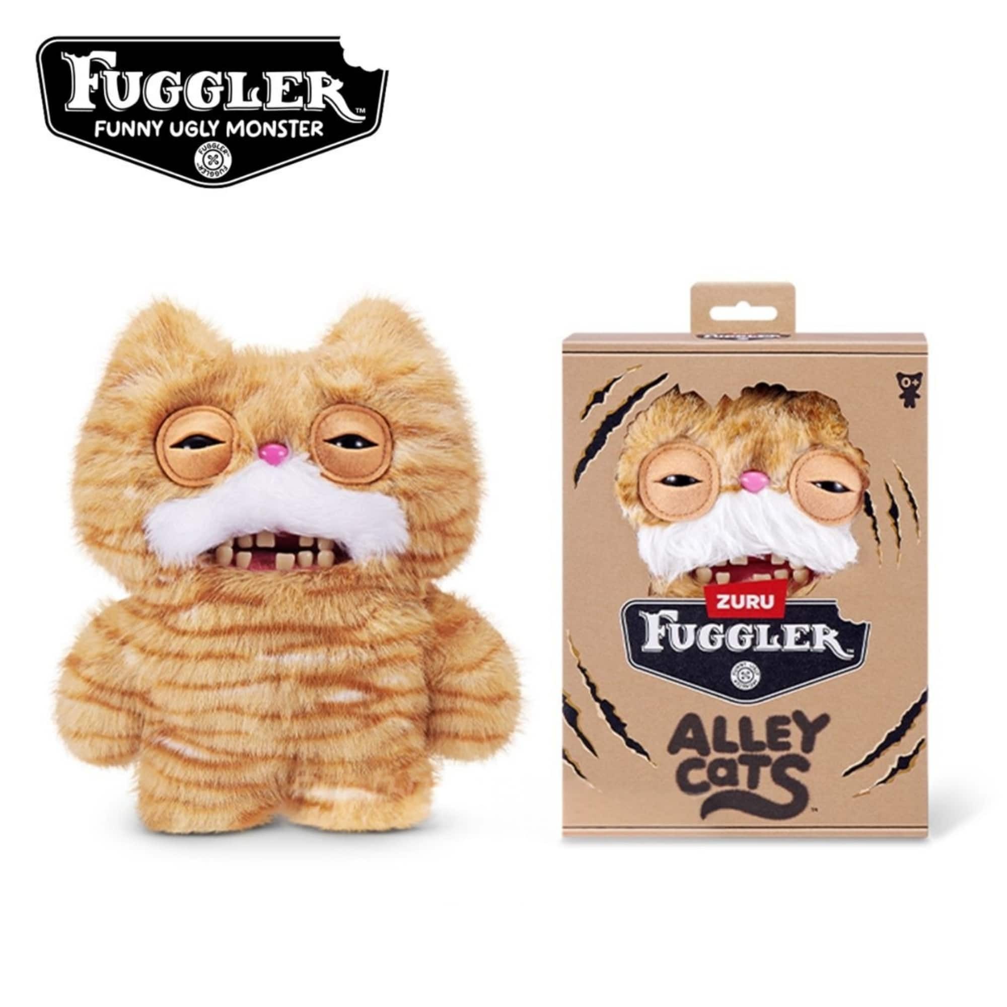 Fuggler Alley Cats Stinkface soft toy features a fluffy orange tabby design with exaggerated facial features, including large eyes and a wide mouth, packaged in a colorful box.