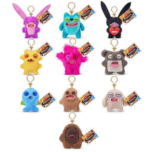 Colorful Fuggler keyrings featuring various quirky designs, including furry creatures with exaggerated teeth, large eyes, and playful expressions, each with a gold keychain attachment.