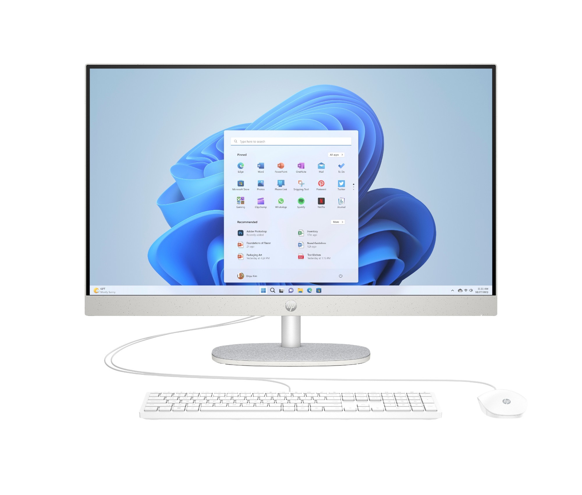 Sleek HP 27-inch all-in-one computer with a silver stand, featuring a 1920 x 1080 display, white keyboard, and mouse, showcasing a Windows 11 interface on the screen.