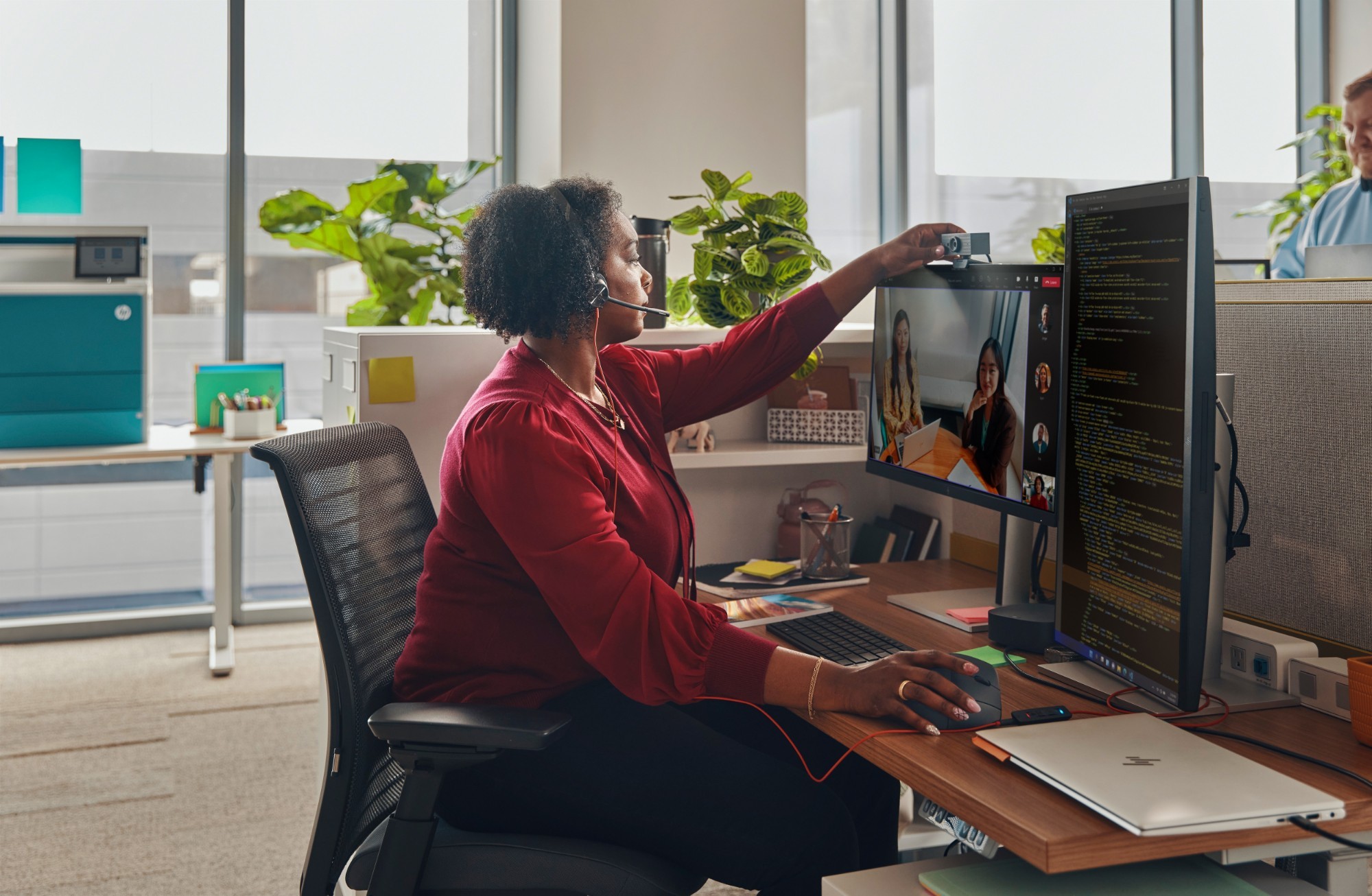 HP Poly Blackwire 3315 USB-A headset in black, featuring a sleek design, adjustable headband, and built-in microphone, worn by a woman in a modern office setting.