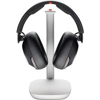 Black HP Poly Voyager Surround 85 UC USB-C headset on a white stand with USB-C/A adapter and charging base.