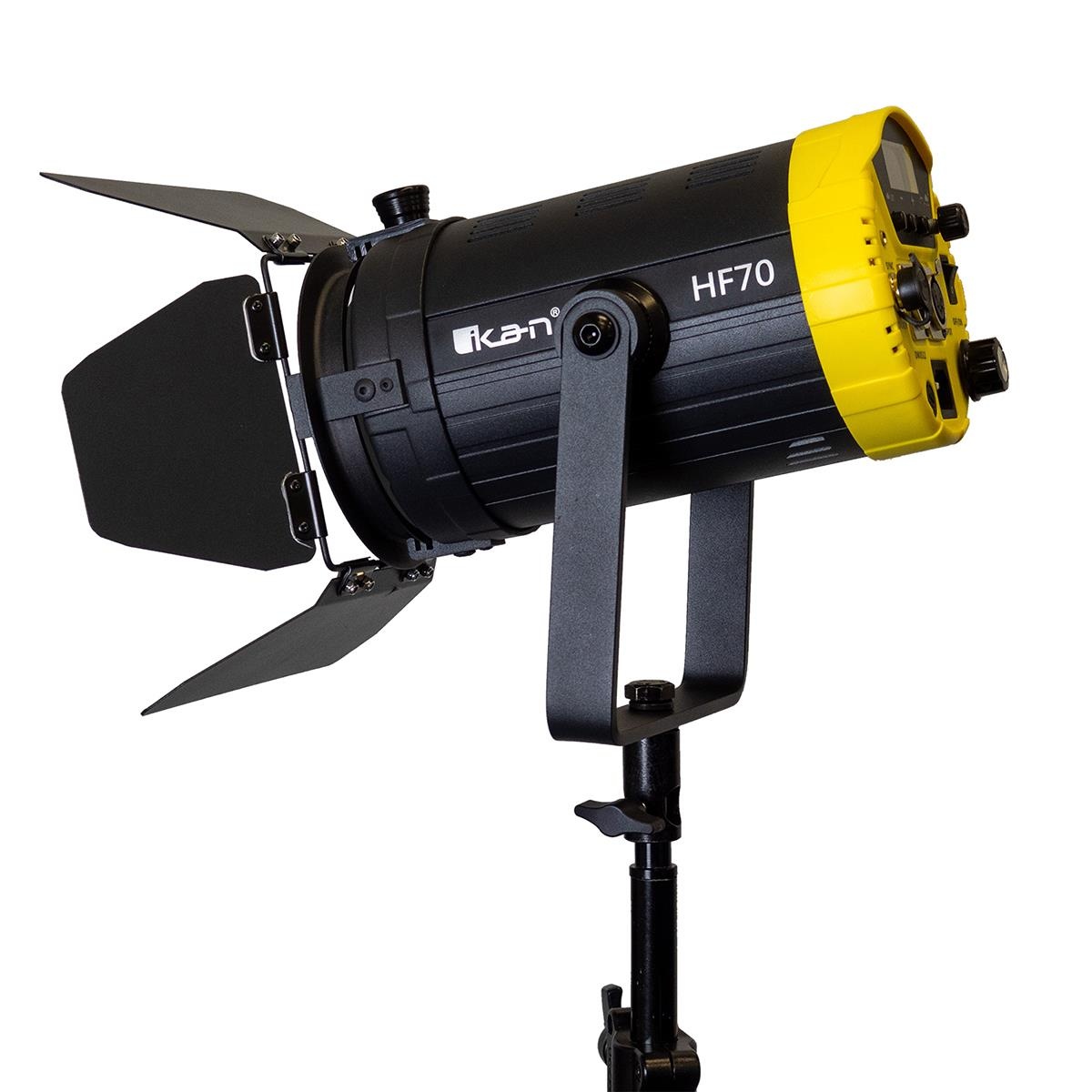 The Ikan HF70 Helia 70W Daylight LED Fresnel Light features a black body with a yellow front, adjustable barn doors, and DMX controls, mounted on a sturdy stand.