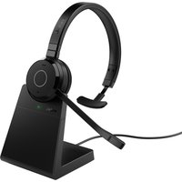 Black Jabra Evolve 65 TE mono headset with boom mic on sleek charging stand, featuring a circular ear pad design.