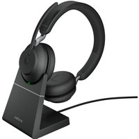 Black Jabra Evolve2 65 USB-A stereo headset on charging stand with cushioned ear cups and adjustable headband.