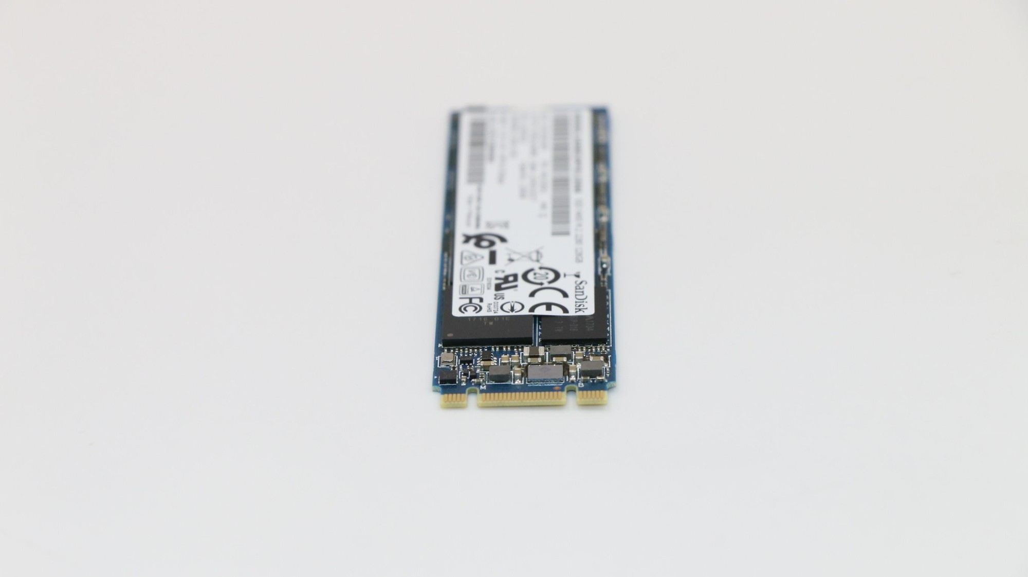 Lenovo 00UP450 512 GB M.2 SSD featuring a blue and black circuit board, gold connectors, and a white label with technical specifications and logos.