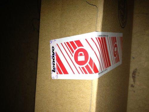 Black Lenovo video cable adapter with VGA (D-Sub) and Mini DisplayPort connectors, packaged in a brown cardboard box with a red security seal.