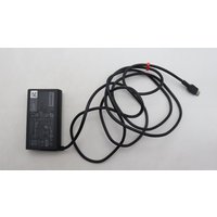 Black Lenovo 65W USB-C AC adapter with UK plug, rectangular design, and long black cable.