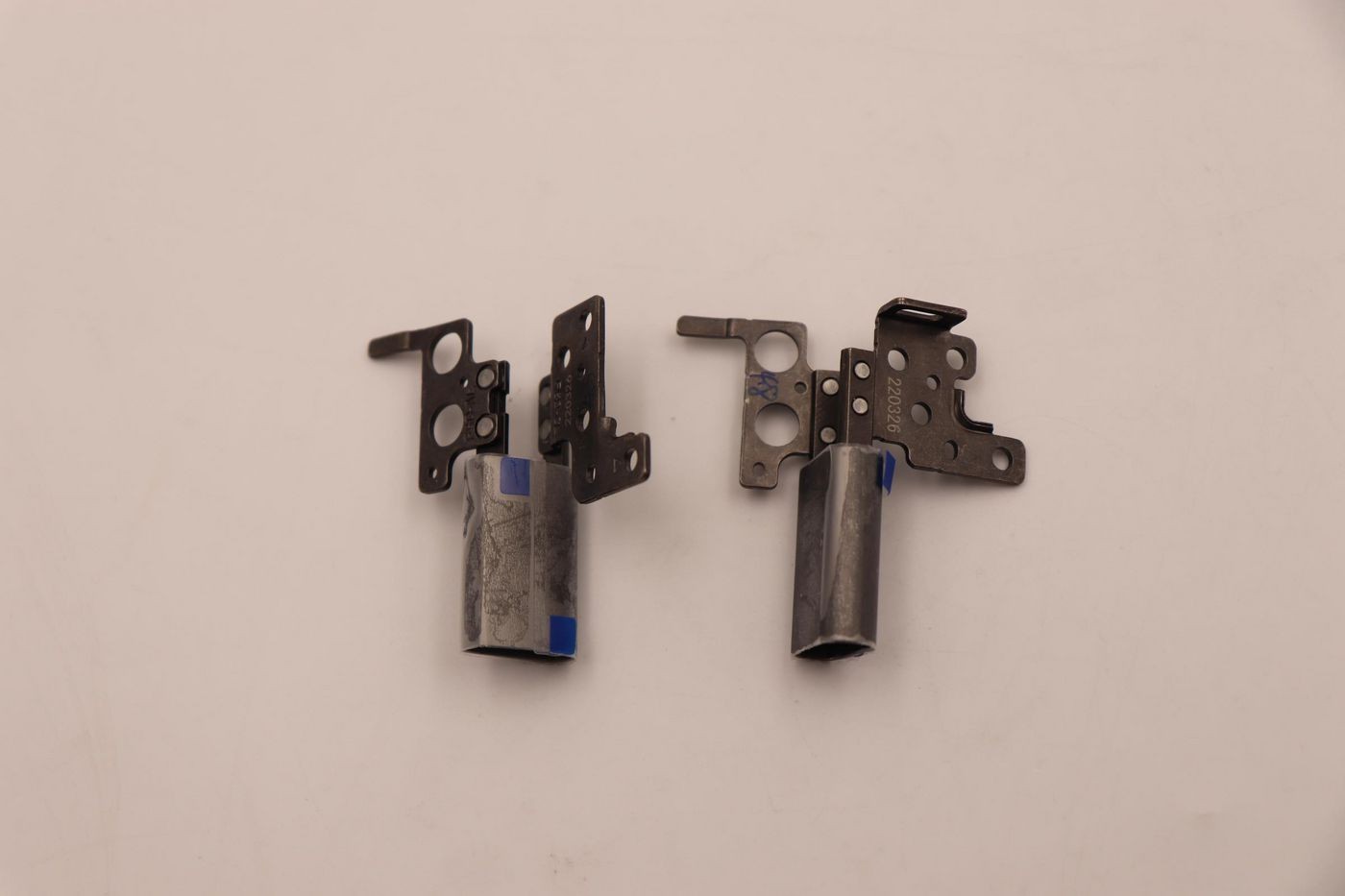 Two metallic Lenovo hinges in gray, featuring multiple holes and brackets for secure attachment, designed for the Lenovo Hinkpd model.