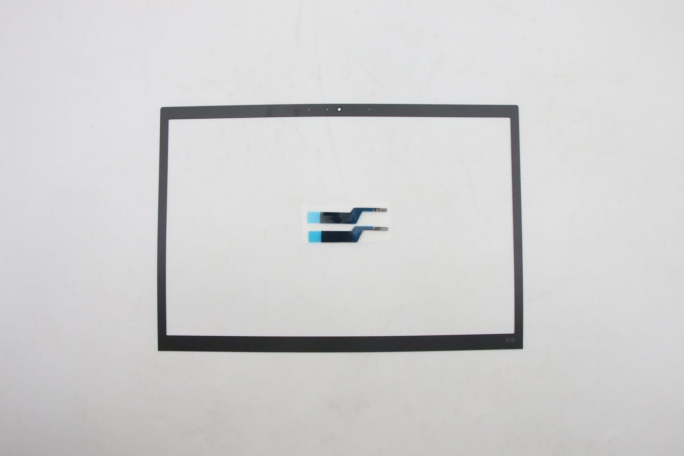 Black Lenovo RG Ezel screen bezel with a smooth finish, featuring cutouts for camera and sensors, accompanied by two small blue and white connectors.