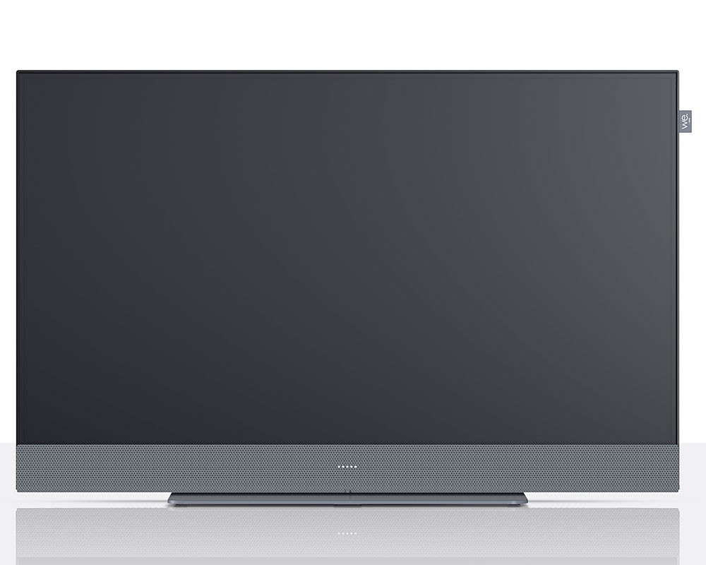 32-inch Loewe We. SEE Full HD LCD television featuring a sleek black screen with a silver mesh speaker grille at the bottom and a minimalist design.