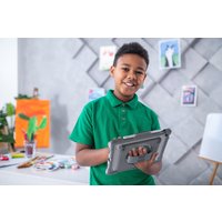 Black bezel-grey iPad case with rugged design, integrated handle, and reinforced corners, held by a child in green shirt.