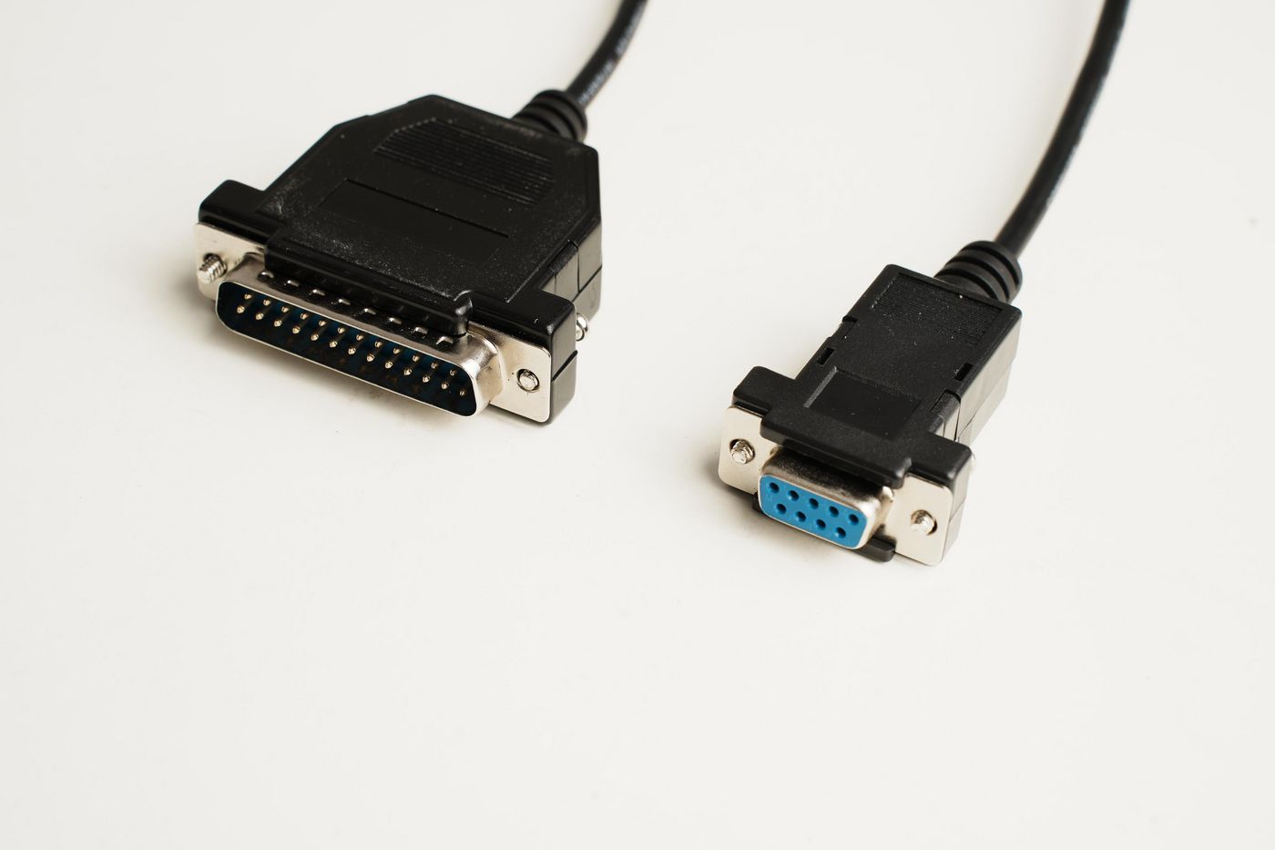 Black 1.8-meter Microconnect serial cable featuring a DB-25 connector on one end and a DB-9 connector on the other, with a durable plastic casing and metal connectors.