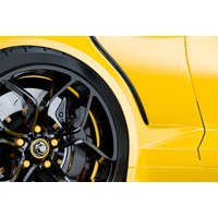 Yellow Chevrolet Camaro with black alloy wheels and sleek body design, part of a muscle car driving experience.