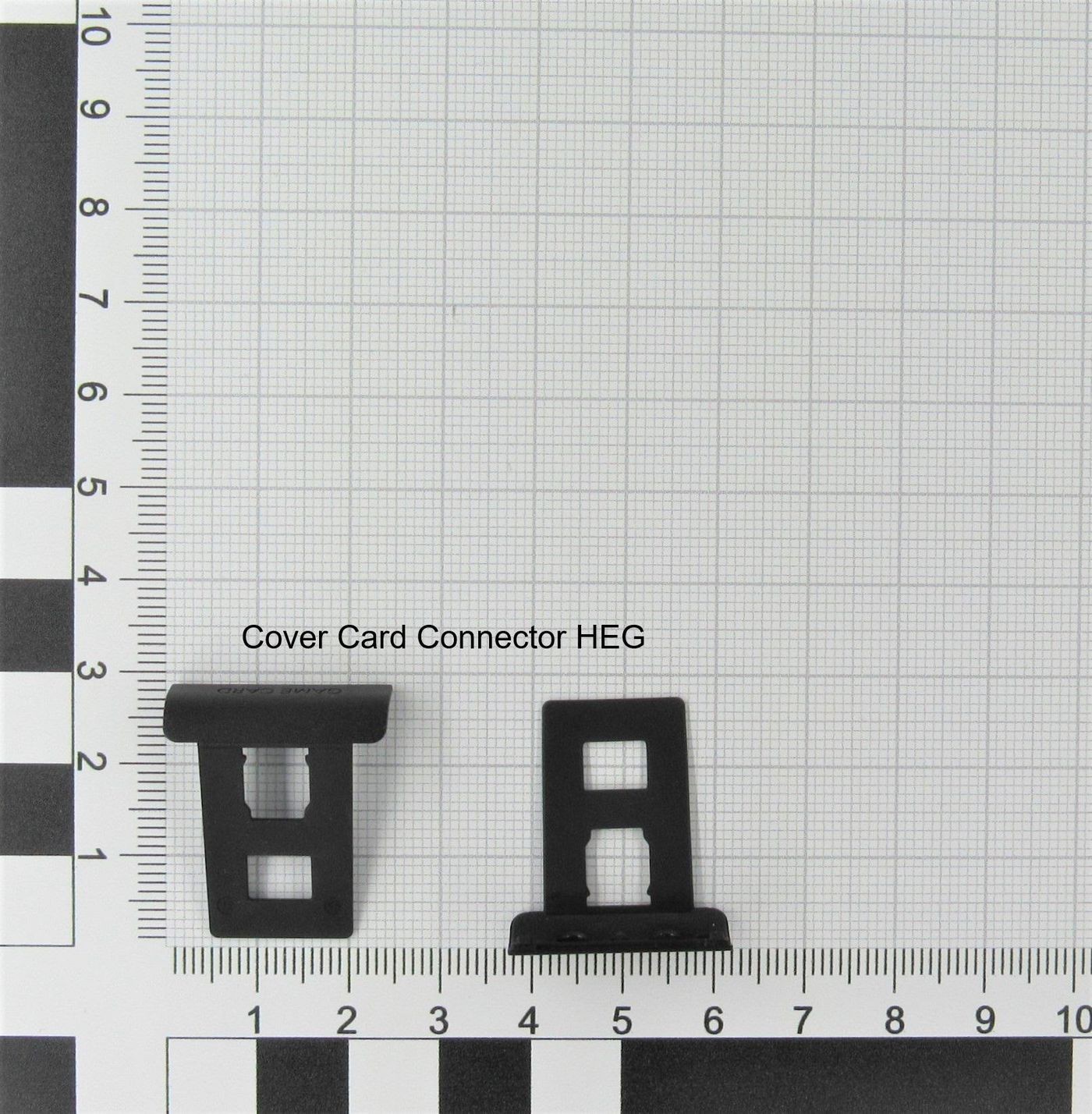 Black plastic cover card connectors with a rectangular shape, featuring a cut-out design, displayed on a grid background for scale.