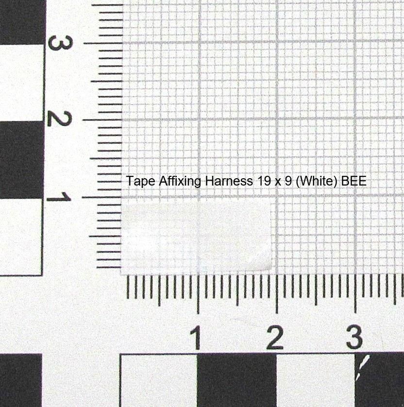 White tape affixing harness measuring 19 x 9, featuring a grid pattern, with a ruler for scale in the background.