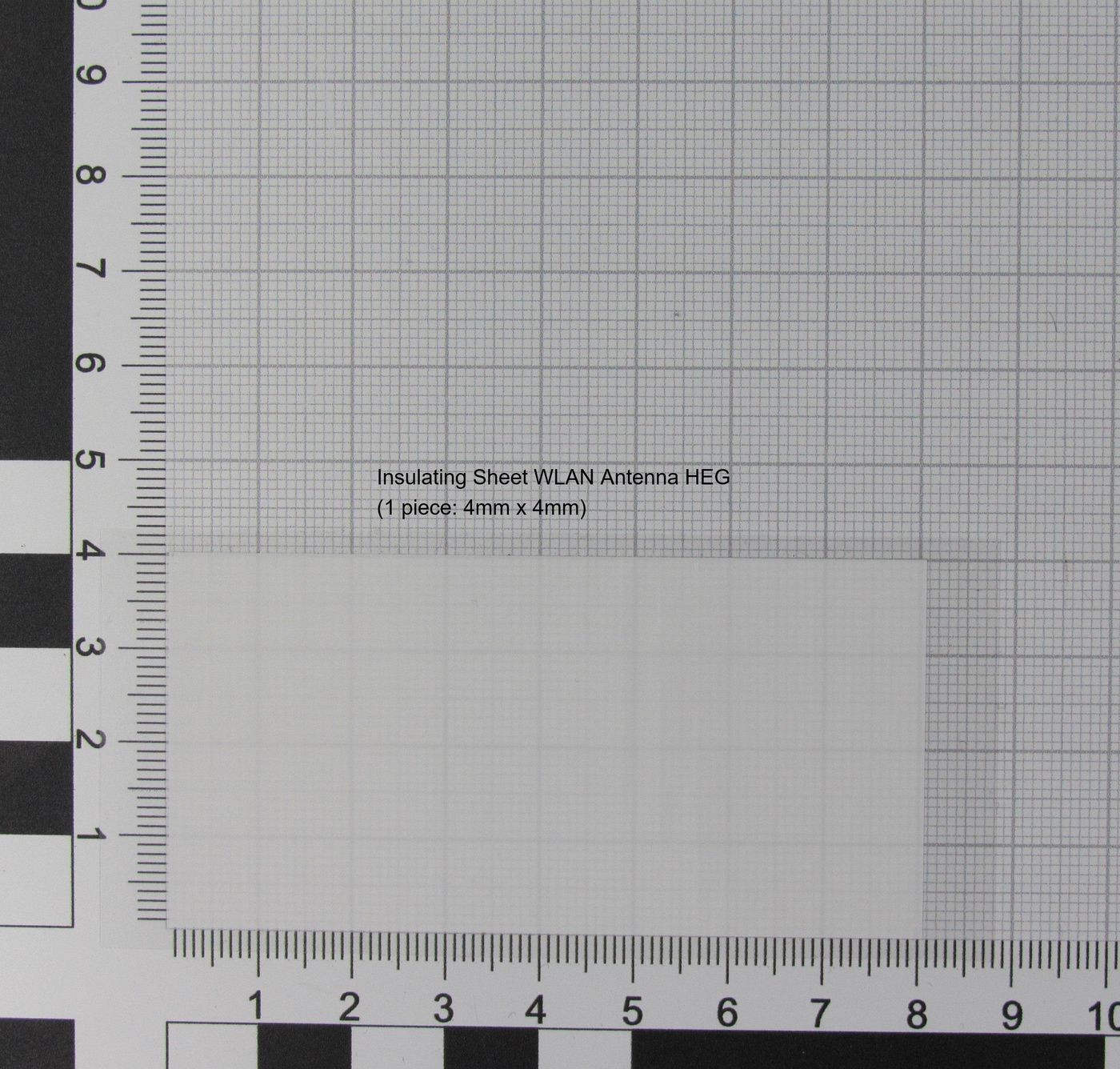 White insulating sheet for WLAN antenna, measuring 4mm x 4mm, displayed on a grid background with measurement markings.