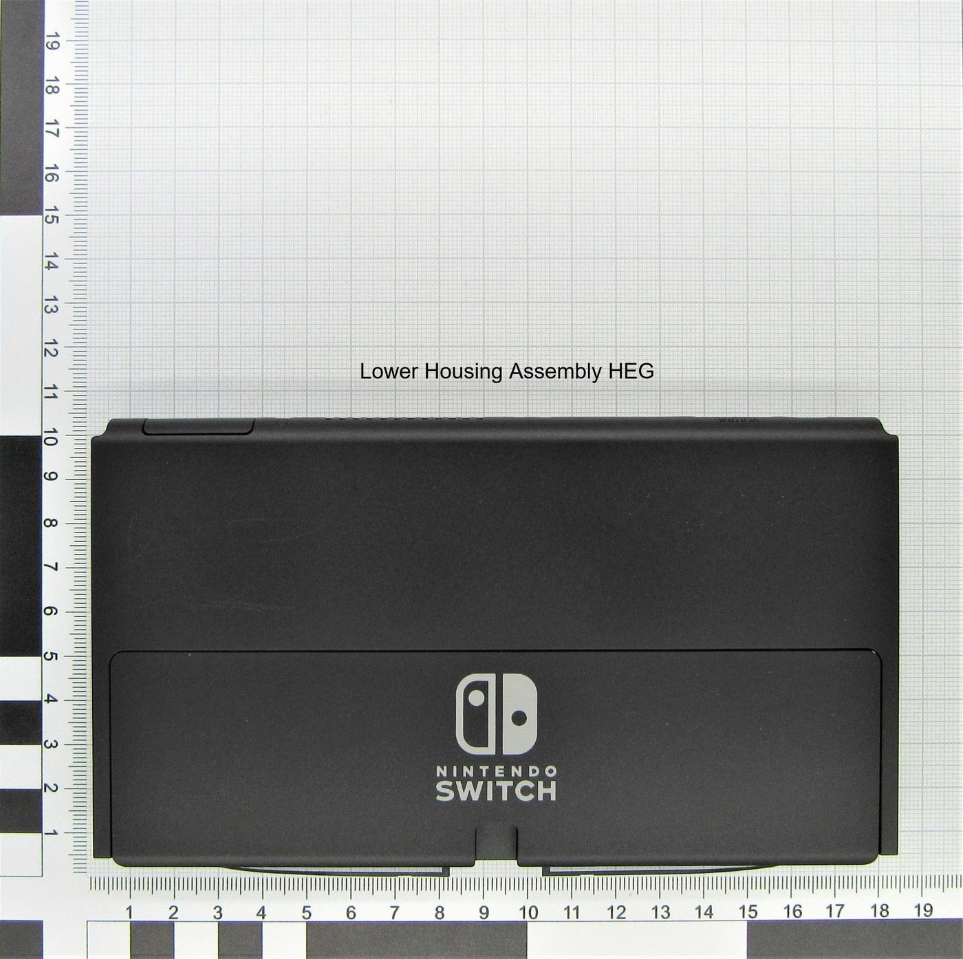 Black lower housing assembly for Nintendo Switch, featuring the Nintendo logo and a sleek design, placed on a grid background for measurement reference.