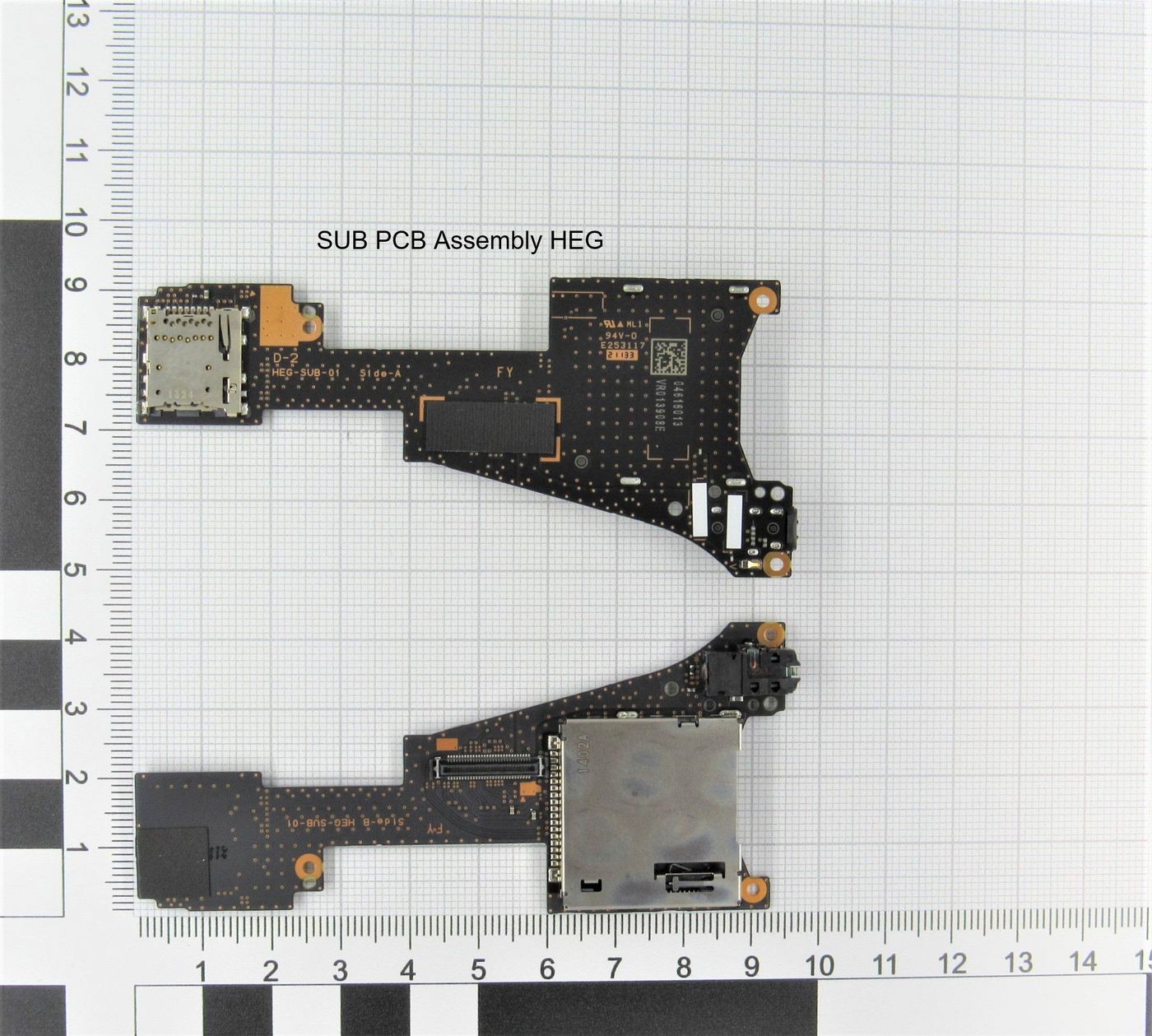 Black printed circuit board assembly with various electronic components, including connectors and chips, labeled "SUB PCB Assembly HEG" on a grid background.