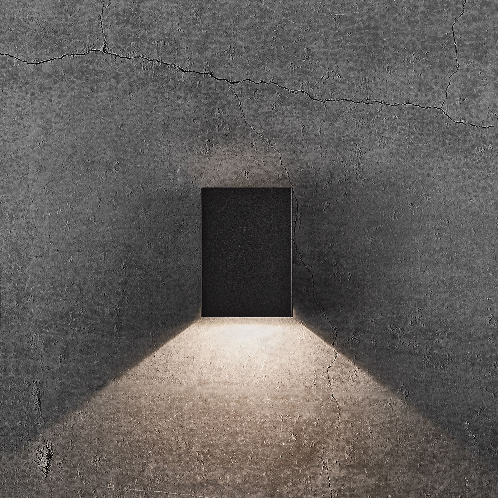 Black rectangular LED wall light with a sleek design, emitting warm light upward and downward, mounted on a textured gray concrete wall.