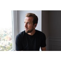 Black Our Pure Planet 700XHP True Wireless EarPods worn by a person, sleek design with compact fit.