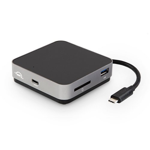 Compact USB-C Travel Dock in Space Gray, featuring a sleek black top, USB-A port, USB-C port, and an SD card slot, connected by a short USB-C cable.