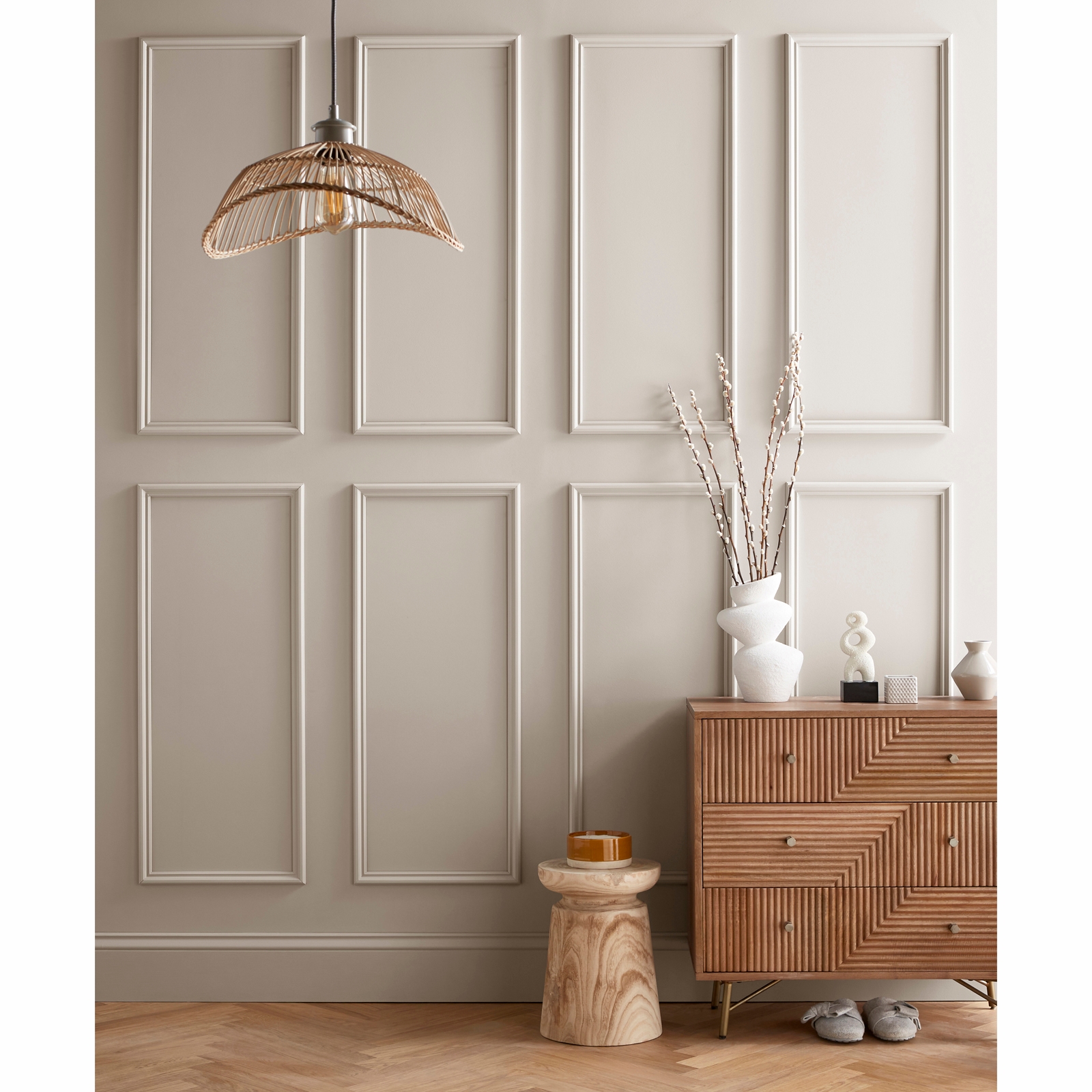 Three rectangular wall panels in a soft beige color, featuring a textured finish, displayed against a neutral wall, complemented by a stylish wooden cabinet and decorative accessories.