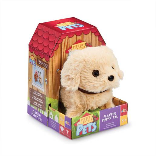 Plush golden lab puppy with soft fur, brown collar, and large expressive eyes, packaged in a colorful box resembling a doghouse, suitable for ages 3 and up.