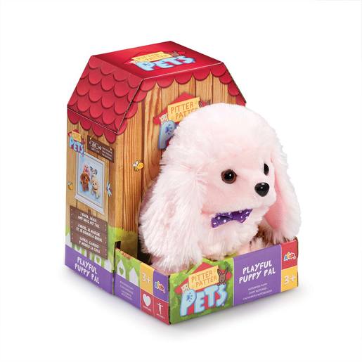 Fluffy pink poodle puppy toy with a purple bow tie, packaged in a colorful house-shaped box featuring playful graphics and a window display. Suitable for ages 3 and up.