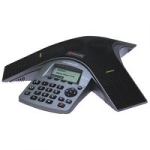 Black and silver conference phone with a sleek design, featuring a keypad, display screen, and integrated speakers for clear audio during meetings.