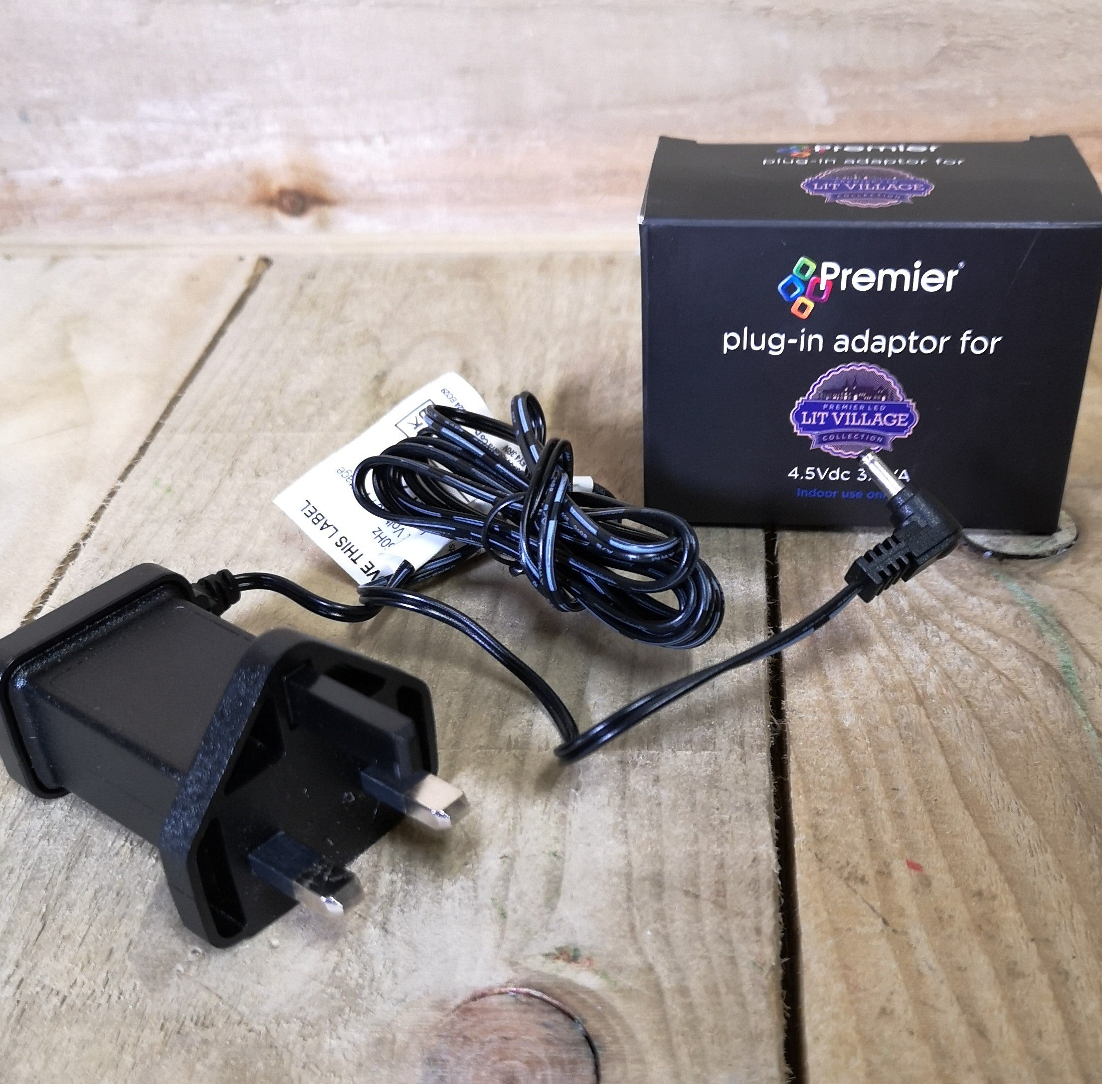Black L-shaped plug-in adaptor with a two-prong connector, featuring a long black cable and a small box labeled "Premier" for Christmas decorations, 4.5Vdc, 3.6VA.