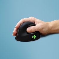 Black ergonomic R-Go Tools mouse with vertical design, Bluetooth, green logo, held in right hand against blue background.
