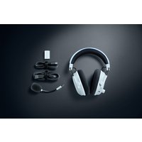 White Razer BlackShark V3 Pro headset with detachable mic, USB Type-A cable, and Bluetooth adapter on dark background.
