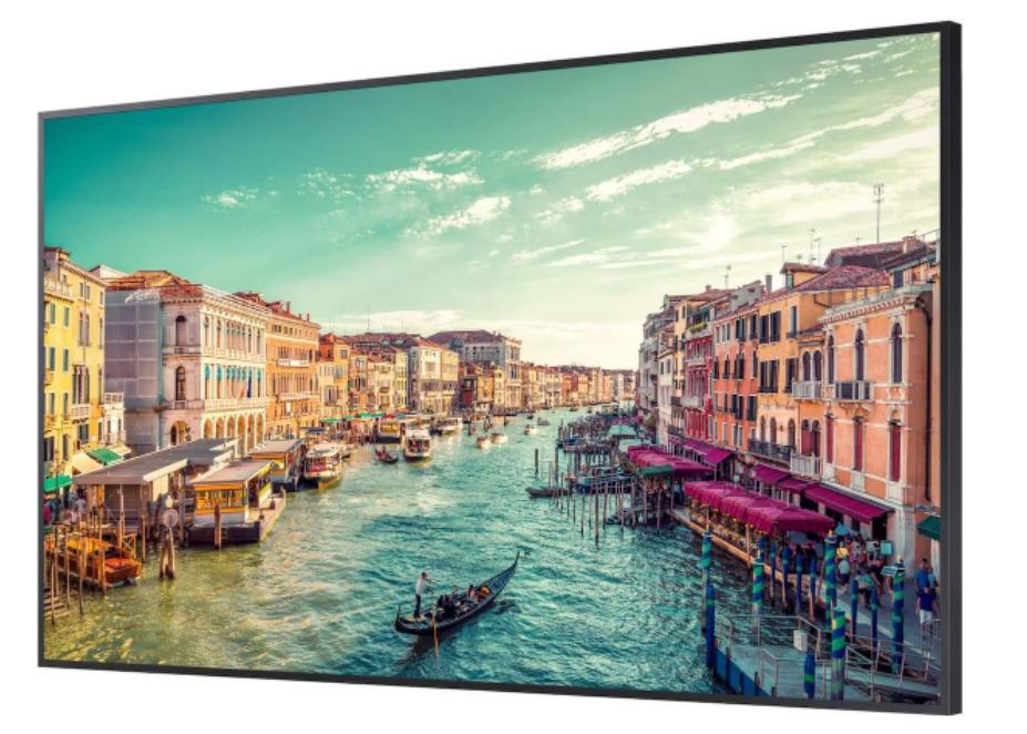 Samsung QB98T-B 98" LCD digital signage panel with a sleek black frame, showcasing vibrant colors and high-resolution imagery of a scenic waterfront view.