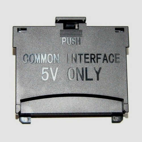 Black plastic connector with "COMMON INTERFACE" and "5V ONLY" printed in white, featuring a push mechanism for easy access.
