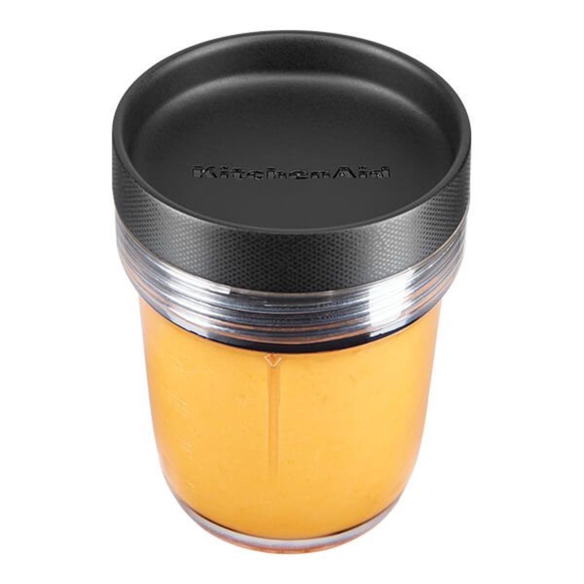 Clear glass jar with a black plastic lid, featuring a textured surface and the KitchenAid logo, designed for use with the K400 blender.