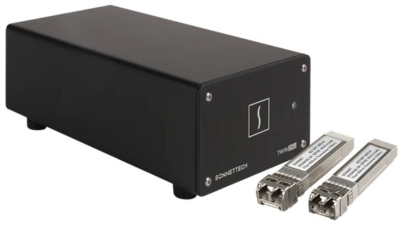 Black metal housing Ethernet adapter with dual Thunderbolt ports, labeled "TWIN25G" and two silver SFP28 transceivers on either side, designed for high-speed 25Gb connectivity.