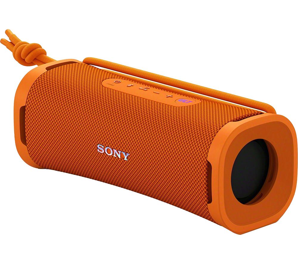 Orange wireless Bluetooth portable speaker with a textured mesh surface, featuring control buttons on top, a sturdy design, and a strap for easy carrying.